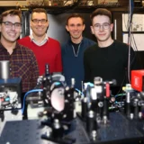 The Tweezer Team at Durham University and their experimental apparatus. From left: Dr. Daniel Ruttley, Prof. Simon Cornish, Dr. Alexander Guttridge, and Mr. Tom Hepworth. Credit: Durham University