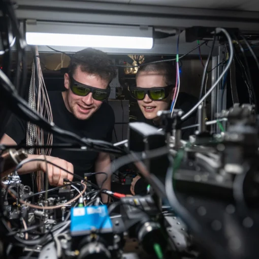 Dougal Main and Beth Nichol working on the distributed quantum computer. Credit John Cairns